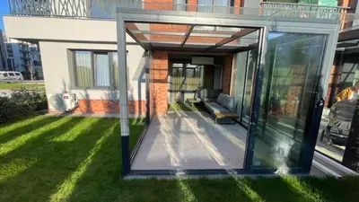 a glass extension of a house with a lawn at Golden Pearl of Luxury - Burgas in Burgas City
