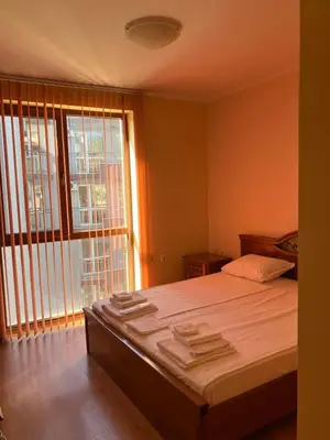 a bedroom with a bed and a large window at Sunny Home 2 in Sunny Beach
