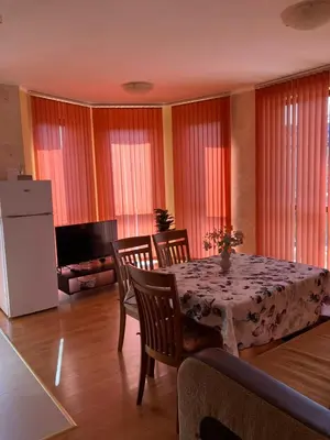 a dining room with a table and chairs and a refrigerator at Sunny Home 2 in Sunny Beach