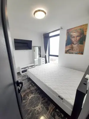 a bed in a room with avertisementatronatronstrationstrationstrationstration at LUXE 1 Venezia Suite in Obzor