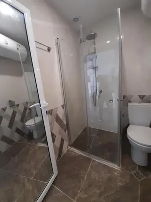a bathroom with a shower and a toilet at LUXE 1 Venezia Suite in Obzor