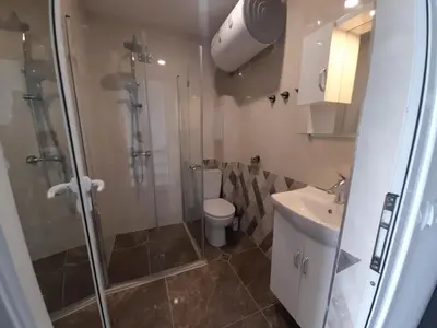 a bathroom with a shower and a toilet and a sink at LUXE 1 Venezia Suite in Obzor