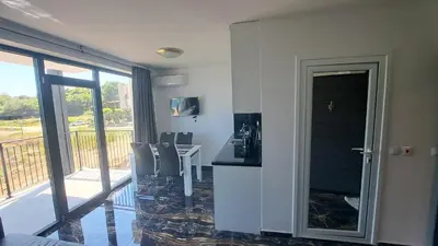 a room with a table and chairs and a balcony at LUXE 1 Venezia Suite in Obzor