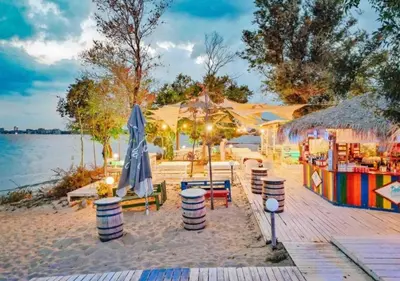 a beach with umbrellas and tables and chairs at Sorrento Sole Mare Sveti Vlas in Sveti Vlas