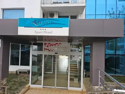 an entrance to an apartment building with a sign on it at Студио за двама в Сарафово in Burgas City