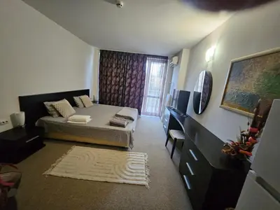 a small room with a bed and a window at Студио за двама в Сарафово in Burgas City