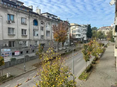 a city street with buildings and trees on the side of a road at Ssenyange Sea Garden Apartment in Varna City