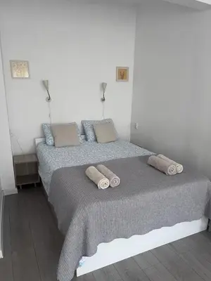 a bedroom with a bed with two pillows on it at Ssenyange Sea Garden Apartment in Varna City