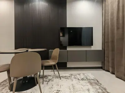 a room with a table and two chairs and a tv at Апартамент Александровска in Burgas City