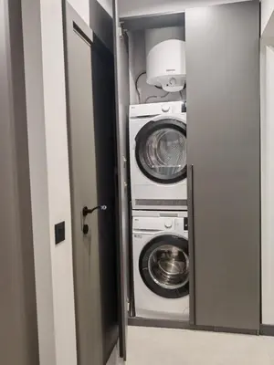 a laundry room with two washer and dryer at Апартамент Александровска in Burgas City