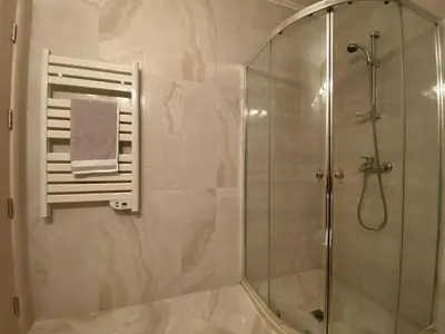 a bathroom with a shower with a glass shower stall at Апартамент в затворен комплекс Артур гр Свети Влас in Sveti Vlas