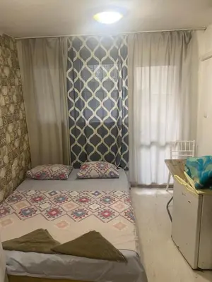 a small bedroom with a bed and a wall at Стая радецки in Varna City
