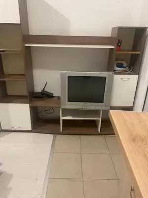 a tv sitting on a stand in a room at Стая радецки in Varna City