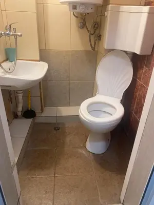 a bathroom with a toilet and a sink at Стая радецки in Varna City