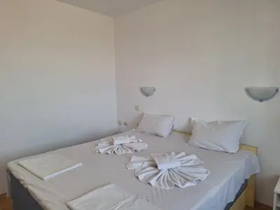 a white bed with towels on top of it at Complex Exotica in Lozenets