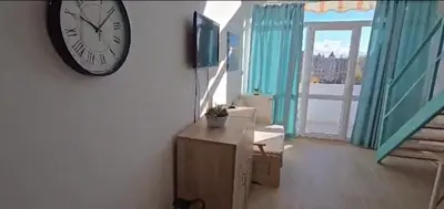 a clock hanging on a wall in a room at Seaview apartment with garden & pool in Sunny Beach