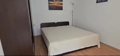 a small bedroom with a white bed in a room at Seaview apartment with garden & pool in Sunny Beach