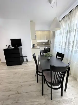 a dining room and kitchen with a table and chairs at Velaria Centre Apartment in Burgas City