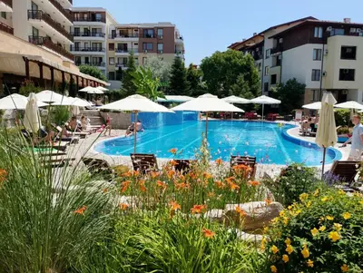 a swimming pool with chairs and umbrellas at Garden of Eden - M303 Rey&Mar Apartaments in Sveti Vlas