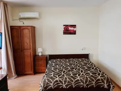 a bedroom with a bed and a dresser and avertisement at Garden of Eden - M303 Rey&Mar Apartaments in Sveti Vlas