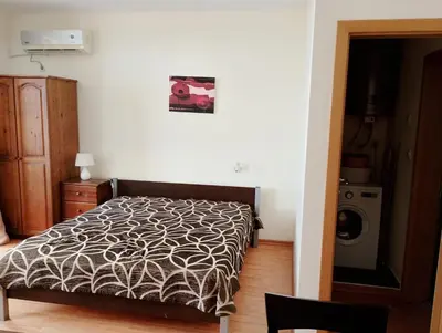 a bedroom with a bed and a washer and dryer at Garden of Eden - M303 Rey&Mar Apartaments in Sveti Vlas