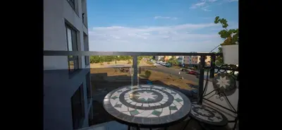 a balcony with a table and a view of a street at Сарафово Дом in Burgas City