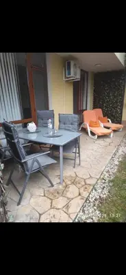 a patio with a table and chairs and a couch at Siana3 in Sveti Vlas