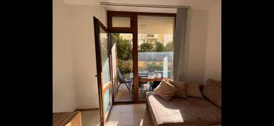 a living room with a couch and a sliding glass door at Siana3 in Sveti Vlas
