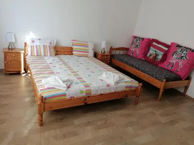 a bedroom with a bed and a couch at Mechta Family Hotel in Obzor