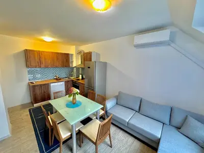 a living room with a couch and a table with chairs at Galateya in Varna City