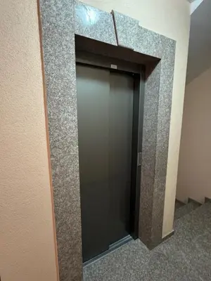 a glass elevator door in a building at Galateya in Varna City