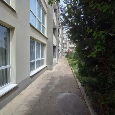 an empty alley between two buildings with a tree at Home Comfort in Sunny Beach