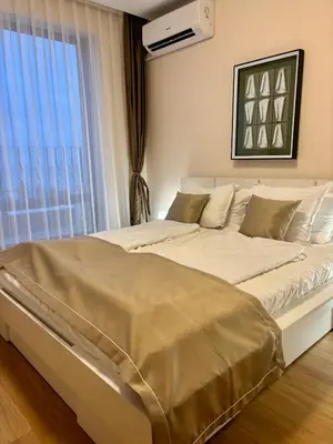 a large bed in a room with a window at Luxury Premier Fort Beach in Sveti Vlas