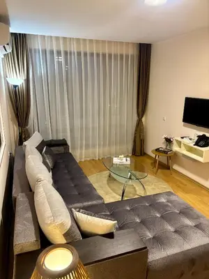 a living room with a couch and a glass table at Luxury Premier Fort Beach in Sveti Vlas