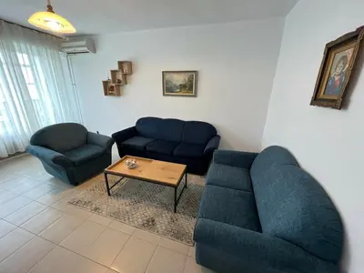 a living room with two blue couches and a coffee table at Home for you, 2-bedroom apartment in Burgas City