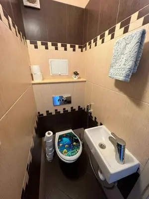 a small bathroom with a toilet and a sink at Home for you, 2-bedroom apartment in Burgas City