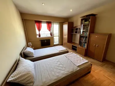 a bedroom with two beds and a window at Home for you, 2-bedroom apartment in Burgas City