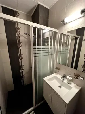 a bathroom with a sink and a shower at Home for you, 2-bedroom apartment in Burgas City