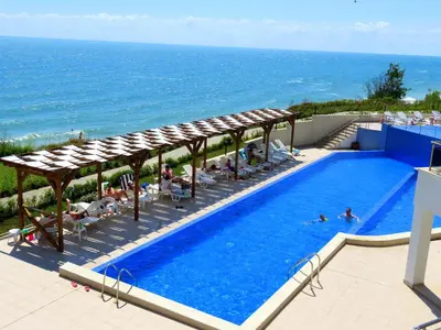 a swimming pool with a view of the ocean at Апартаменти Бяла Клиф - Byala Cliff Apartments in Byala
