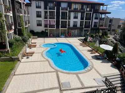 a swimming pool in front of a building at Camping Gradina Sunny Bay Appartment in Chernomorets