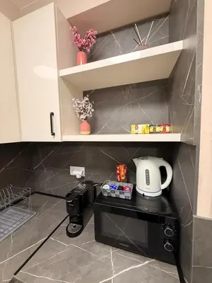 a kitchen with a coffee maker on top of a microwave at Danny Apartment Welcomes You in Burgas City