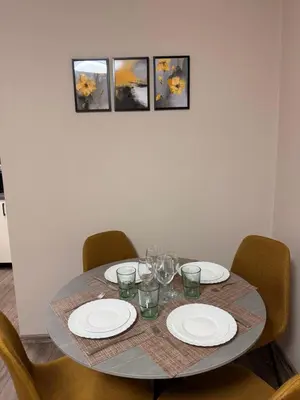 a table with plates and wine glasses on it at Danny Apartment Welcomes You in Burgas City