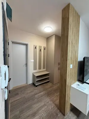 a room with a hallway with a door and a television at Danny Apartment Welcomes You in Burgas City