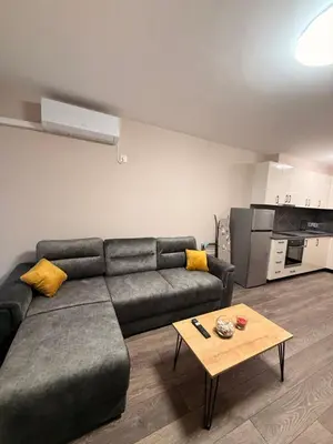 a living room with a couch and a table at Danny Apartment Welcomes You in Burgas City