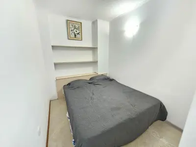 a small bedroom with a bed in the corner at PALAZZO FAMILY SUITE Sunny beach in Sunny Beach