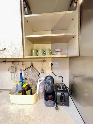 a kitchen cabinet with a kitchen appliance on a counter at 'Tide Frame' Apartment - Big, Super Central, 2 bathrooms in Burgas City