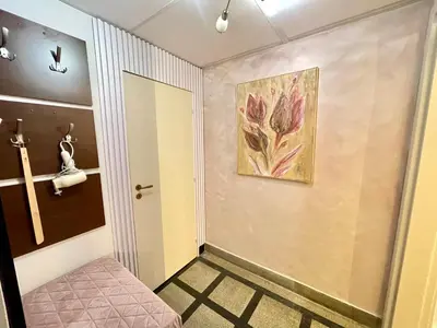 a hallway with a door and a painting on the wall at 'Tide Frame' Apartment - Big, Super Central, 2 bathrooms in Burgas City