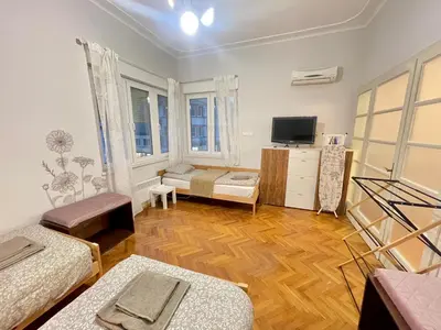 a living room with two beds and a television at 'Tide Frame' Apartment - Big, Super Central, 2 bathrooms in Burgas City