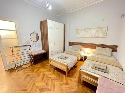 a room with two beds and a mirror at 'Tide Frame' Apartment - Big, Super Central, 2 bathrooms in Burgas City