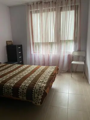 a bedroom with a bed and a chair and a window at Balkan Breeze 7 - Rey&Mar Apartaments in Sunny Beach